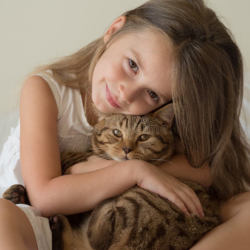 Little girl with cat stock image. Image of camera, care 103245169