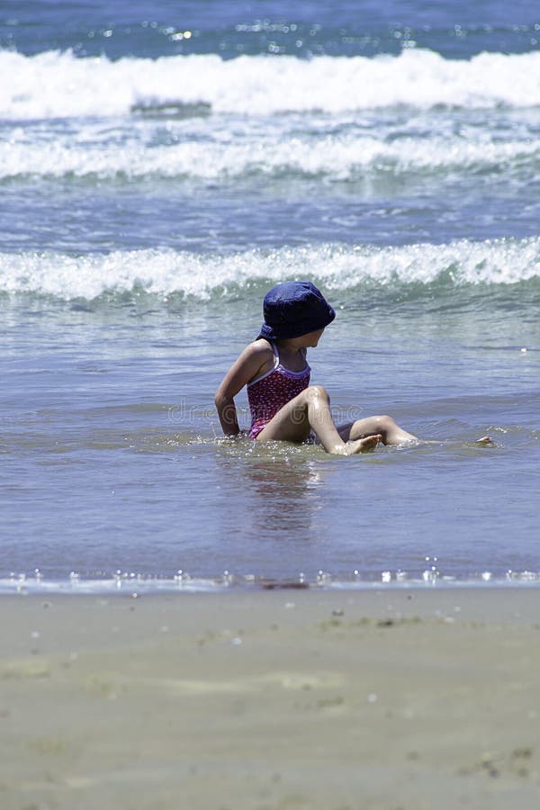 Little girl child enjoy the water of the sea