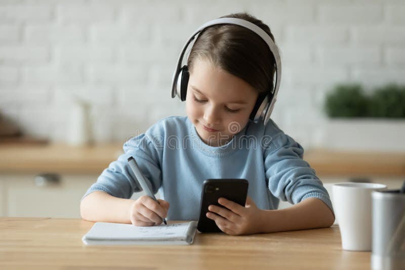 Little girl child study online using cellphone