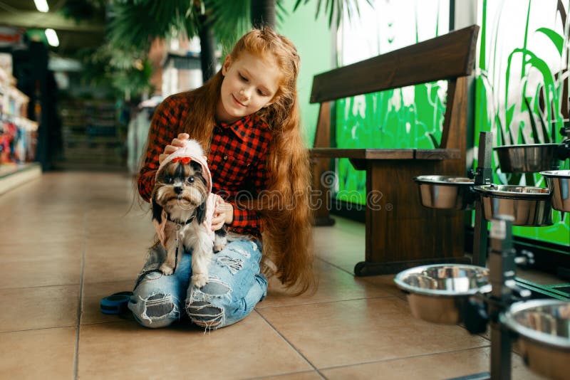 https://thumbs.dreamstime.com/b/little-girl-choosing-clothes-dog-pet-store-little-girl-choosing-clothes-her-dog-pet-store-child-buying-equipment-169108530.jpg