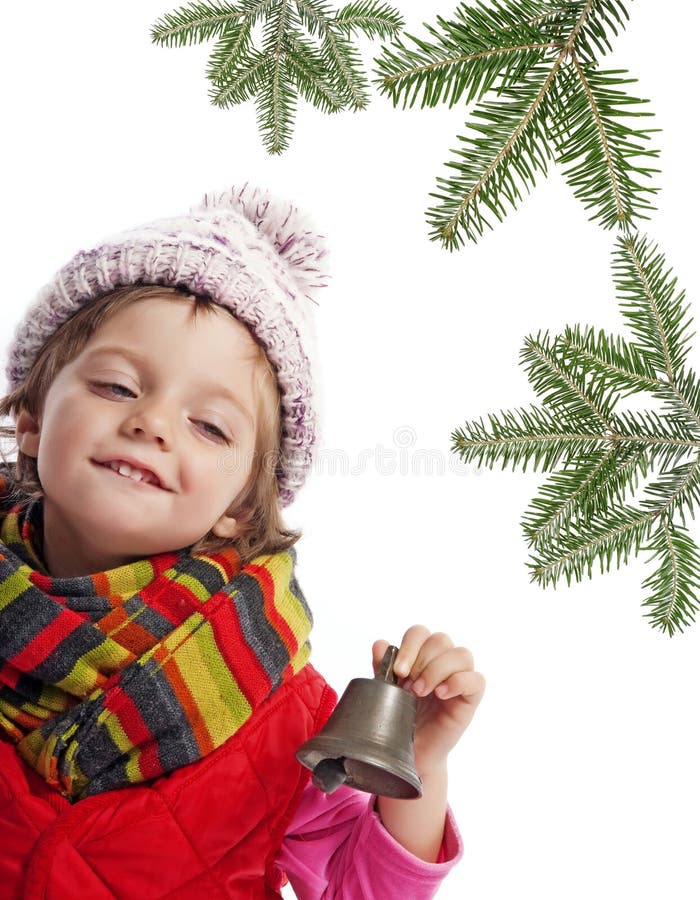 Little girl with christmas bell and spruce tree