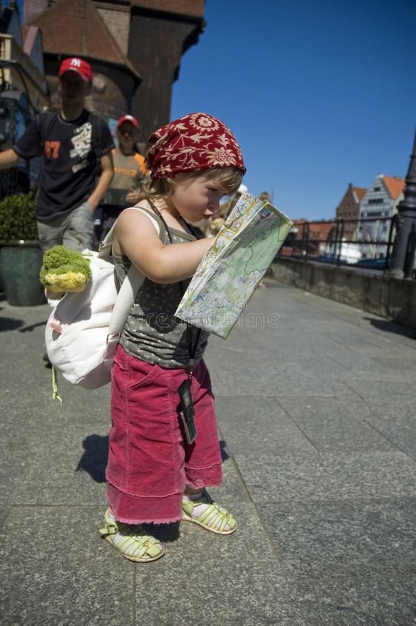 Little girl with a city map. travel