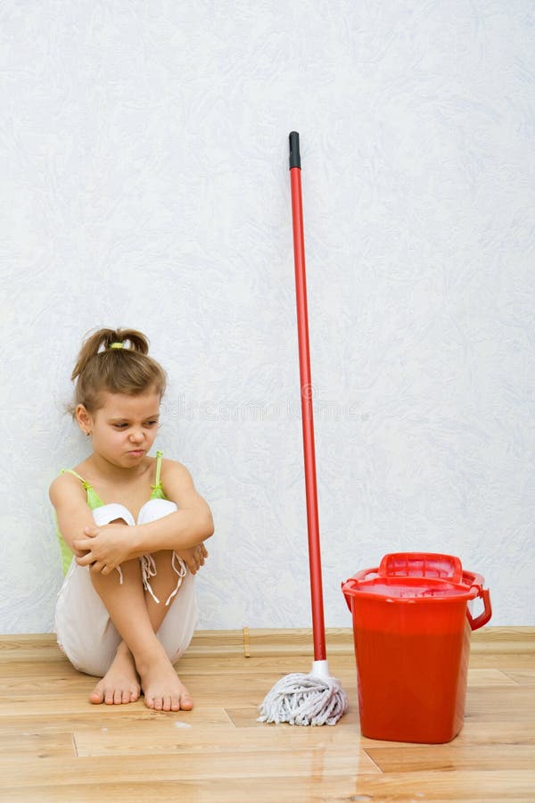 Little girl cleaning the floor royalty free stock photo