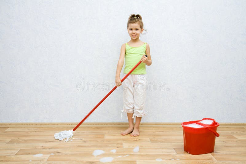 Little girl cleaning the floor stock images