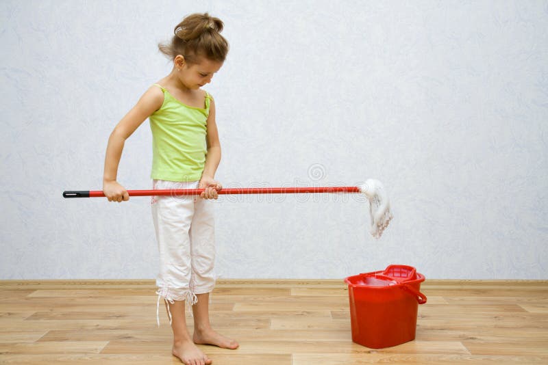 Little girl cleaning the floor