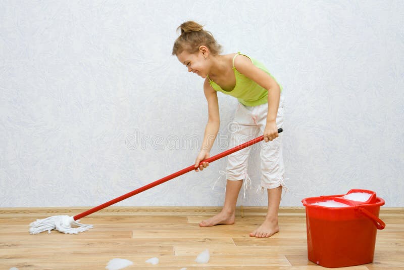 Little girl cleaning the floor stock image