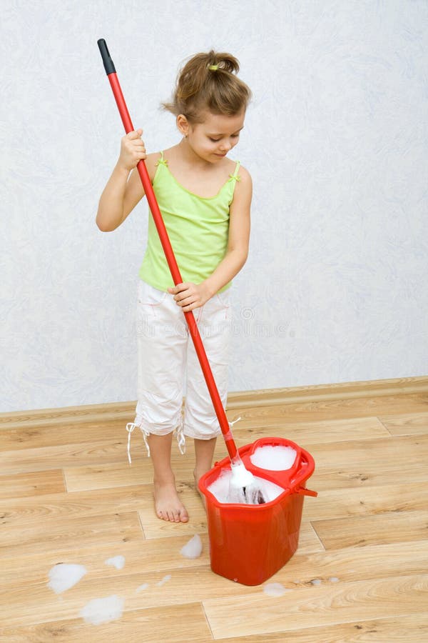 Little girl cleaning the floor stock image
