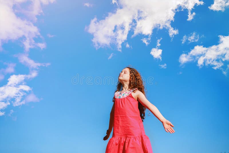 Little girl closed her eyes and breathes the fresh air