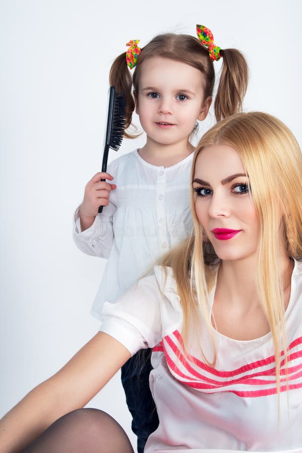 Little girl combing her hair mom royalty free stock images Little girl combing her hair mom royalty free stock images