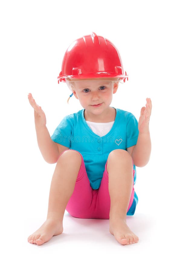 Little girl in the construction red helmet on head