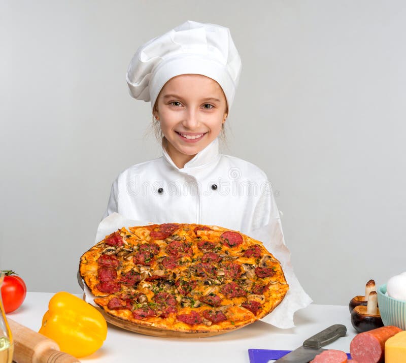 Little girl-cook with pizza in hands