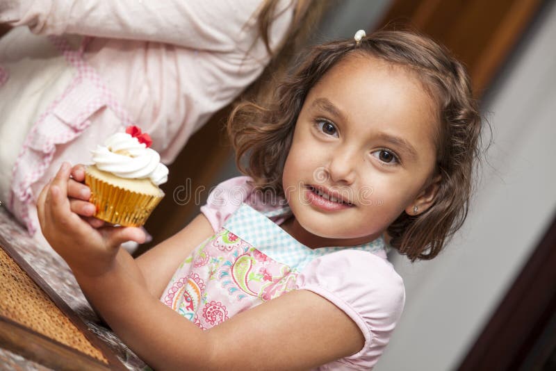 Little girl with a cupcake stock image. Image of cook 74354081