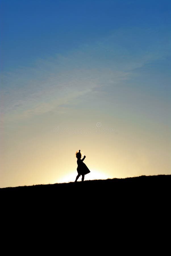 Little girl dancing on hill