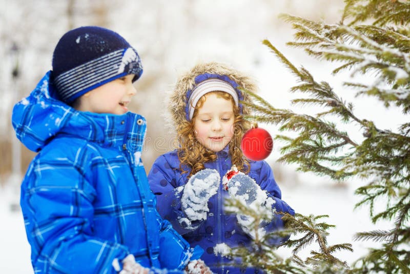 Little girl decorates the Christmas tree. stock image Little girl decorates the Christmas tree. stock image