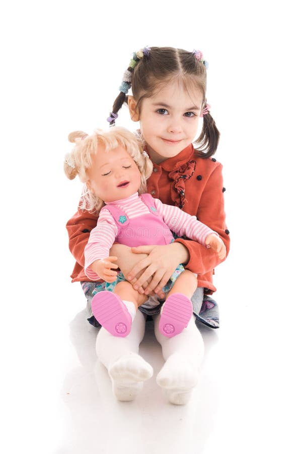 The little girl with a doll isolated on a white