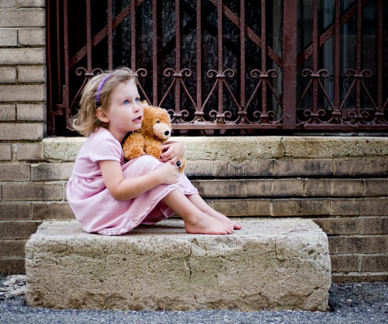 Little Girl Dreaming on Concrete Step with Teddy Bear