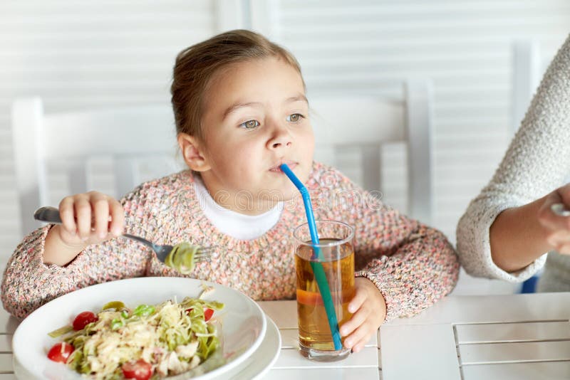 Little Girl Drinking Apple Juice at Restaurant Stock Photo - Image of ...