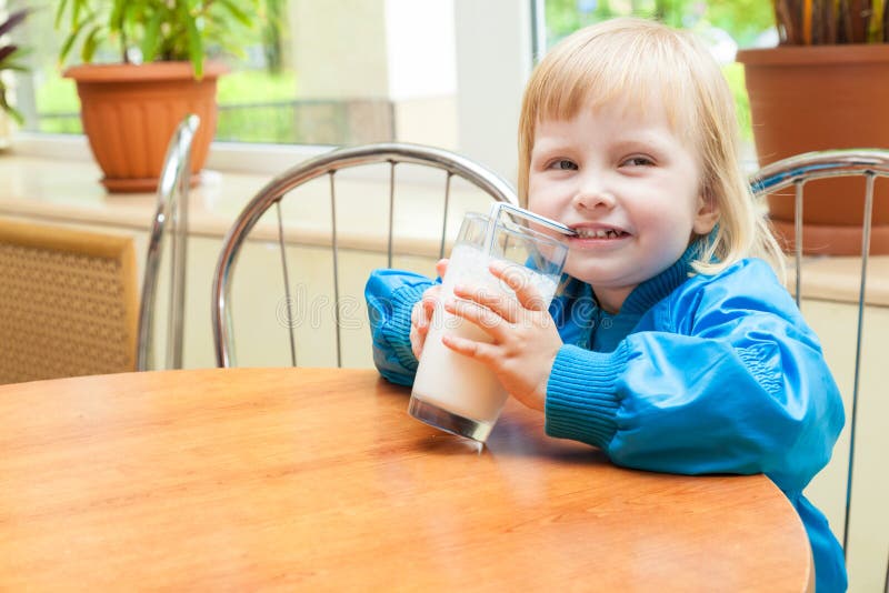 Little girl is drinking milk royalty free stock images Little girl is drinking milk royalty free stock images