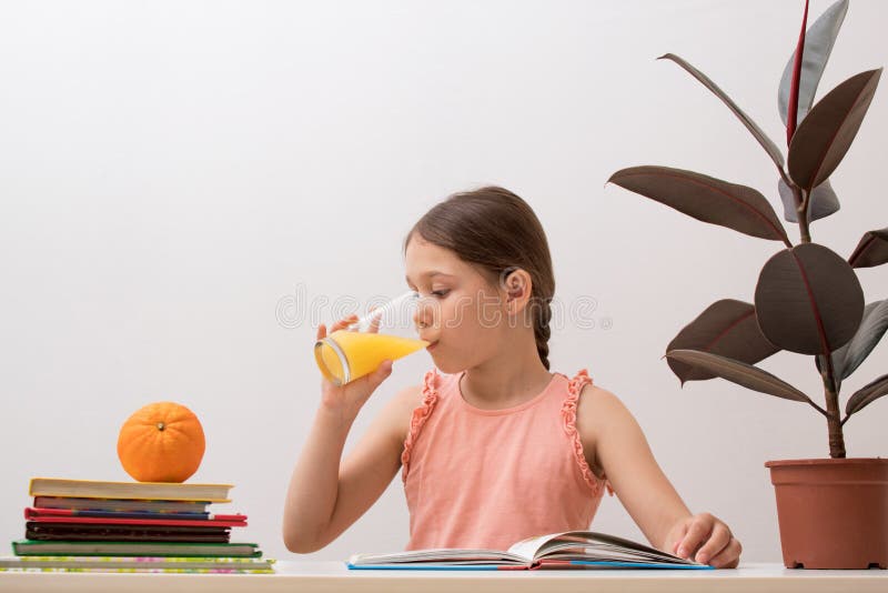 Beautiful Little Girl Drinks Orange Juice. The Concept Of ...