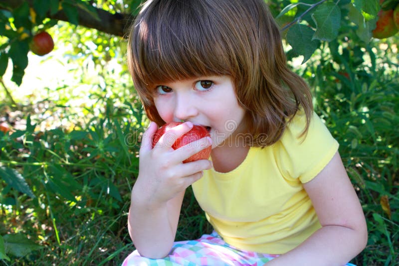 Little girl eating apple