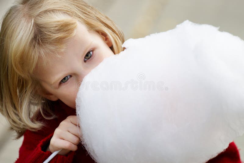 Little girl eating cotton candy