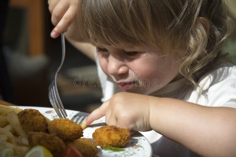 Little girl eating french fries