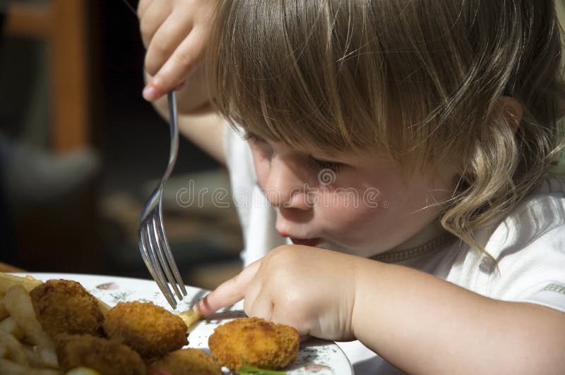 Little girl eating french fries