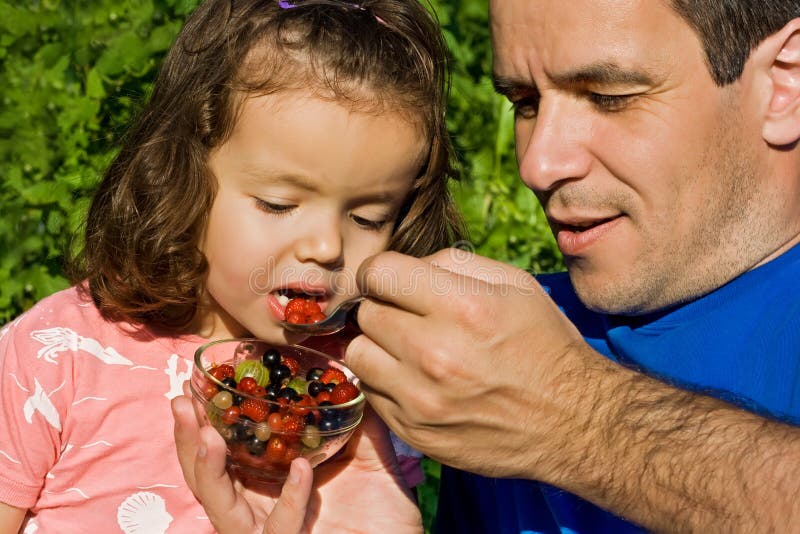 Little girl eating fruits