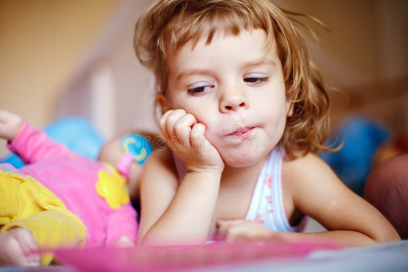 Little girl eating grapes on bed stock photos Little girl eating grapes on bed stock photos