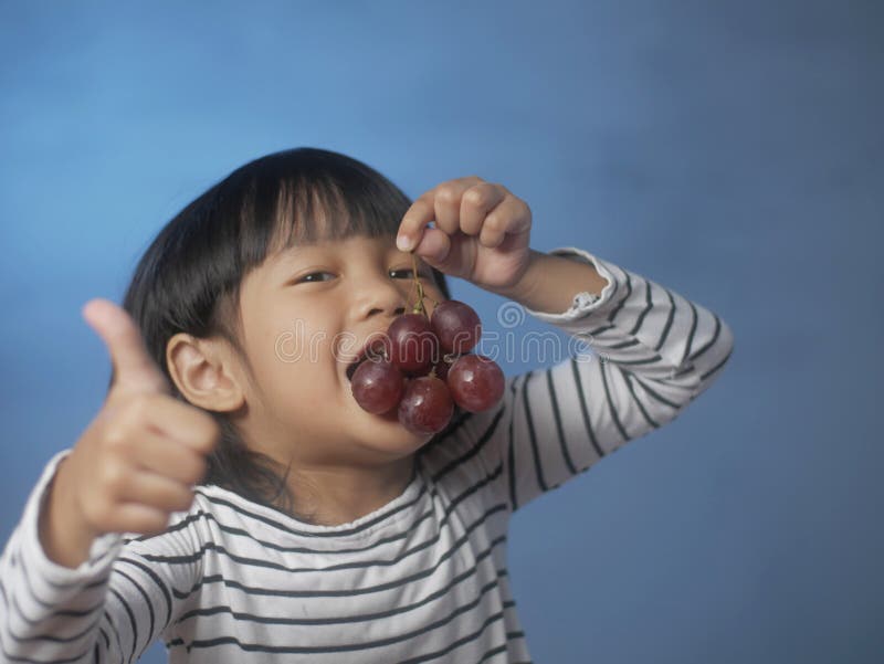 Little Girl Eating Grapes