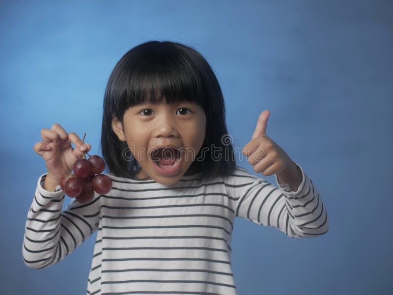 Little Girl Eating Grapes