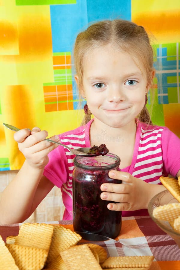 Little girl eating jam stock photo. Image of home, cherry 16696430