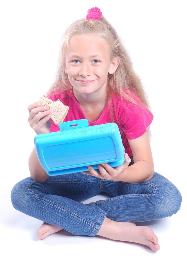 Little girl eating from lunch box stock images Little girl eating from lunch box stock images