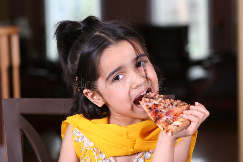 Little girl eating a pizza slice