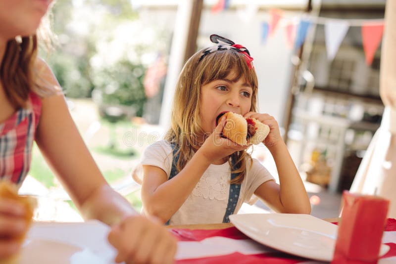 Little girl eating snacks at a restaurant stock photography Little girl eating snacks at a restaurant stock photography
