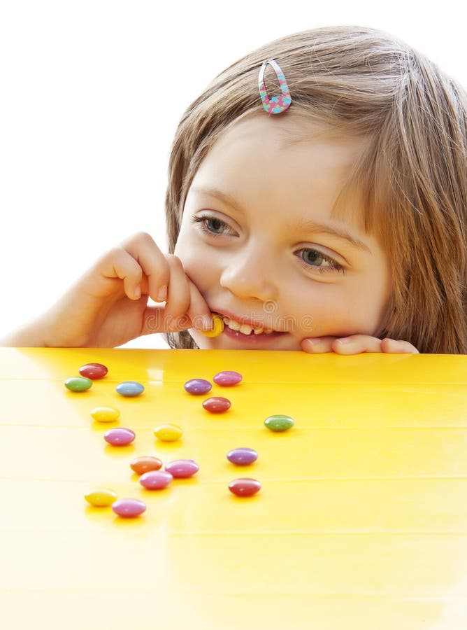 Little Girl Eating Sweets Royalty Free Stock Photography - Image: 21879847