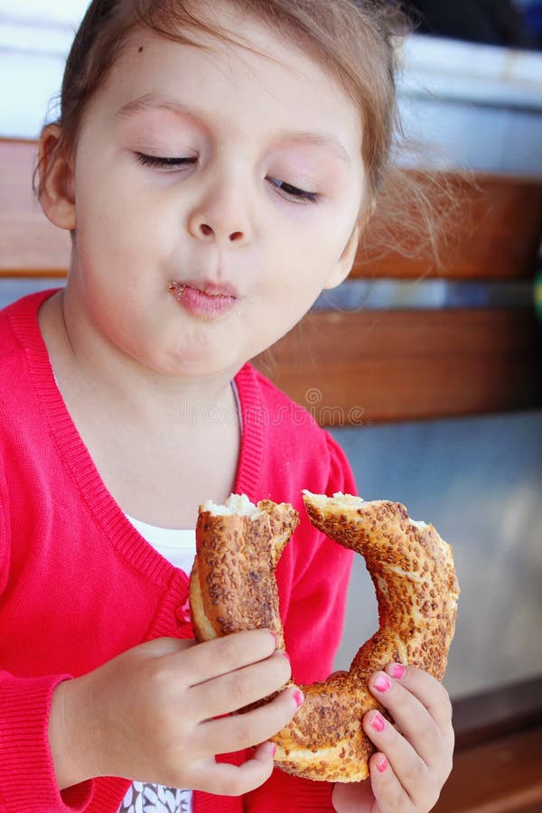 Little girl eating turkish bagel. stock photography