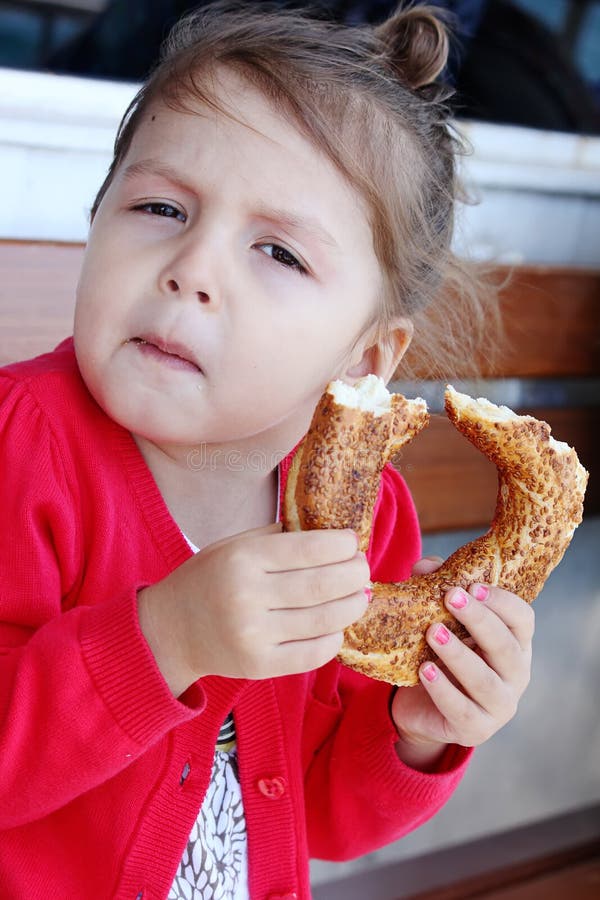 Little girl eating turkish bagel. royalty free stock photography