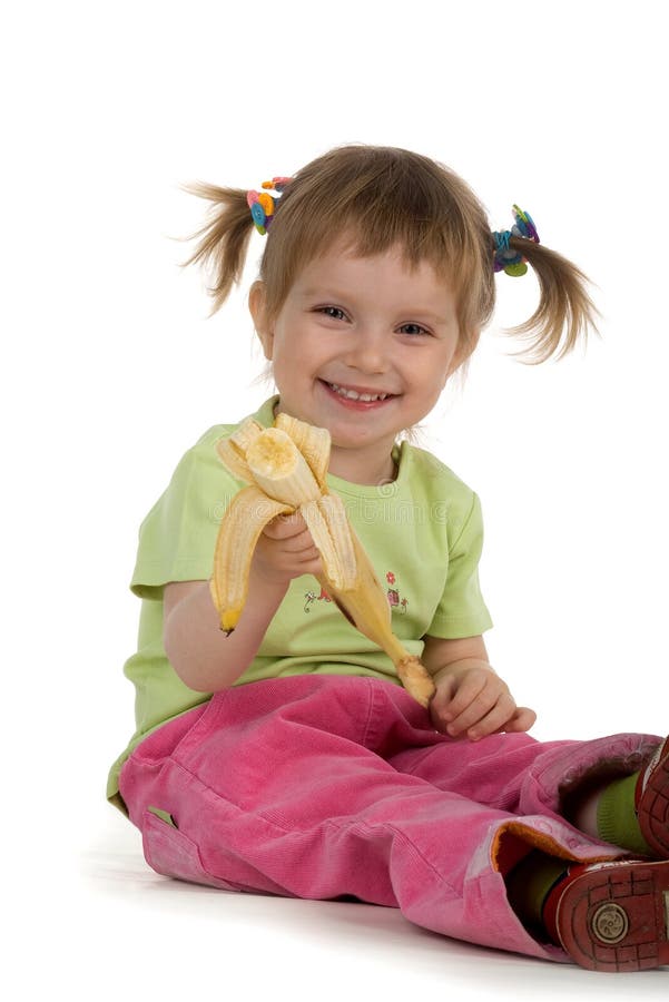 Little girl eats a banana