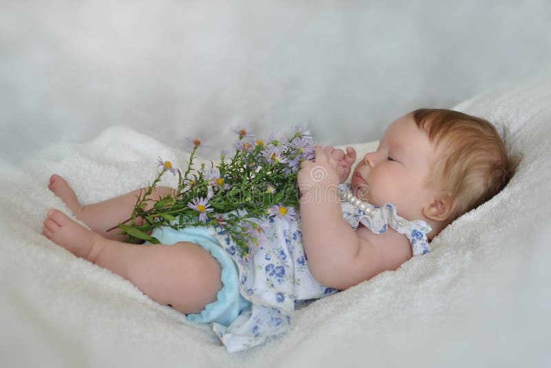 Little girl explores flowers stock photography Little girl explores flowers stock photography