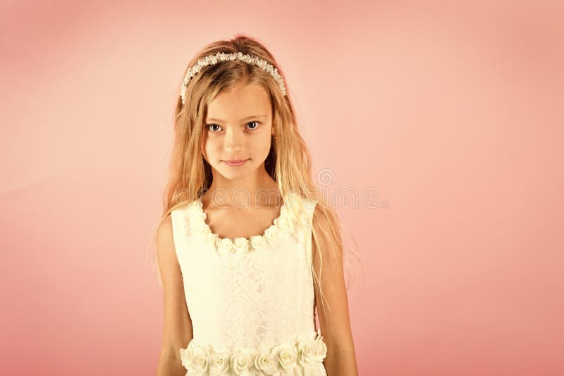 Little girl in fashionable dress, prom. Child girl in stylish glamour dress, elegance. Fashion model on pink background, beauty. Look, hairdresser, makeup. Fashion and beauty, little princess