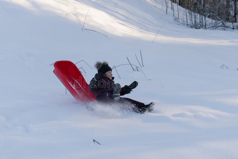 A Little Girl Fell Off Her Sled while Sliding Down a Hill in Winter ...