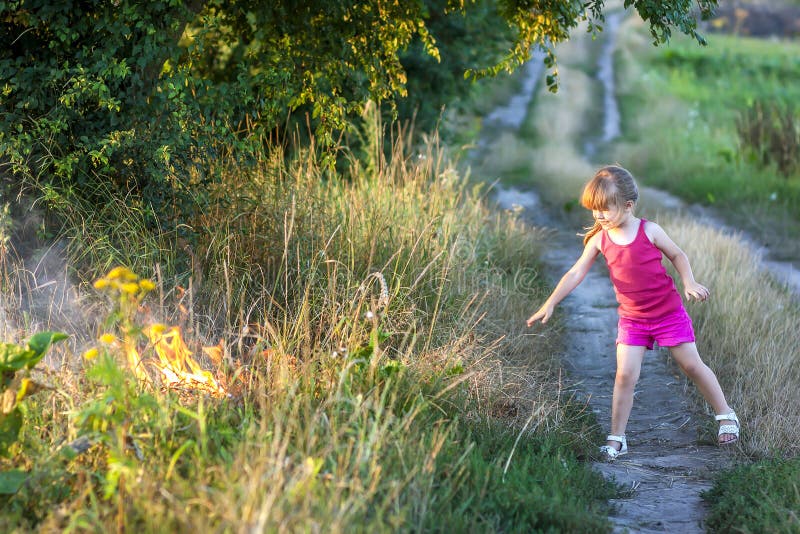 Little Girl Field Road Playing Fire Stock Photos Free & RoyaltyFree Stock Photos from Dreamstime
