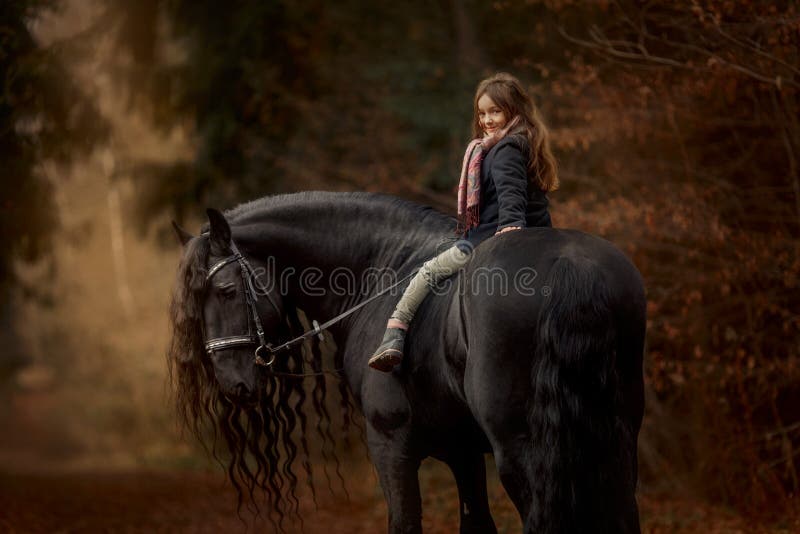 Girl with friesian horse autumn forest royalty free stock photos Girl with friesian horse autumn forest royalty free stock photos