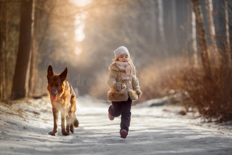 Little girl with German shepherd dog at early spring