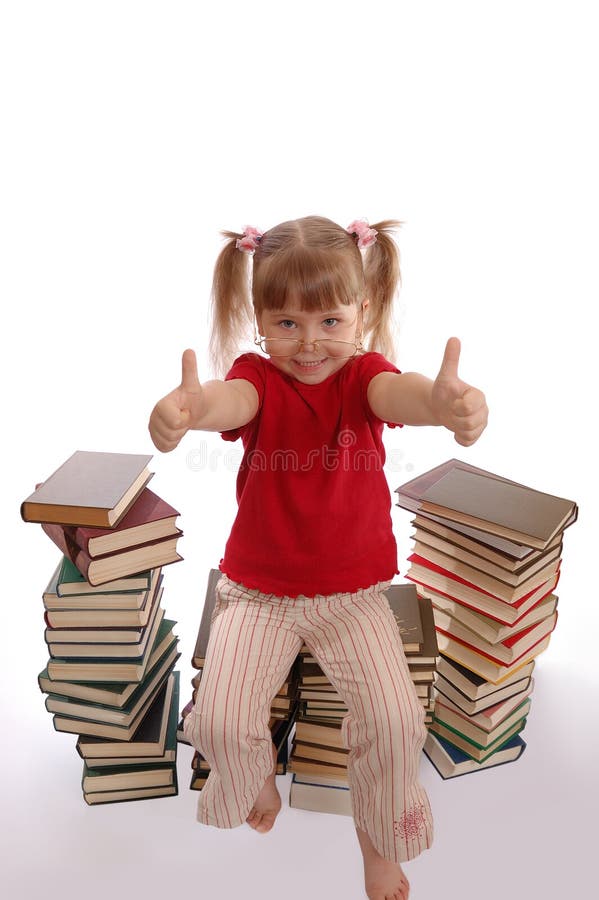 The little girl in glasses sits on books