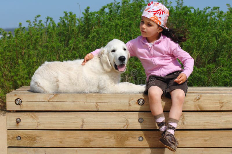 Little girl with a Golden retriever