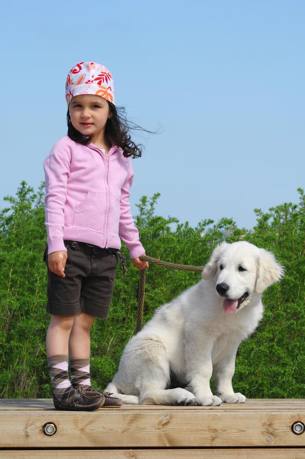 Little girl with a Golden retriever