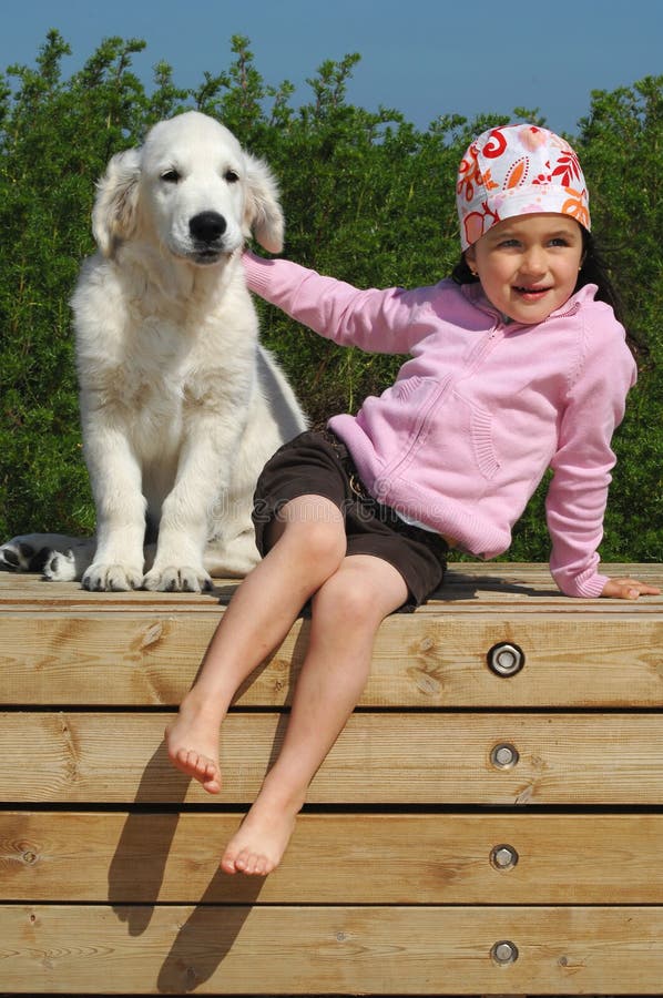 Little girl with a Golden retriever