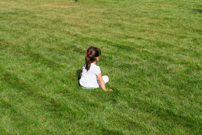 Little girl on the grass. 